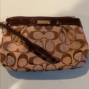 Brown coach logo wristlet
